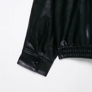 Women's faux leather jacket with high collar featuring elastic hem and button cuffs