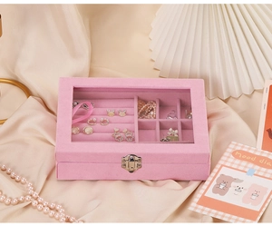 Detail view of pink velvet jewelry box with clear dustproof lid and metal lock