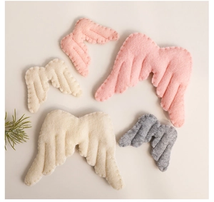 Detail of multi-colored felt angel wing decorations with stitching for Christmas decor