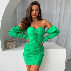 Detail of green ruched mini dress with long sleeves and front tie closure design