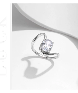 Detailed macro shot of an oval-cut diamond and irregular S925 silver wavy ring