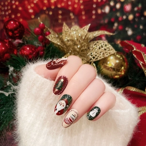 Christmas almond press-on nails featuring Santa, snowman, and holiday tree patterns