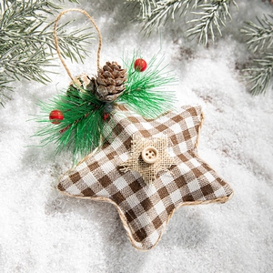 Christmas star ornament with burlap, pine cones and berries on white snow background