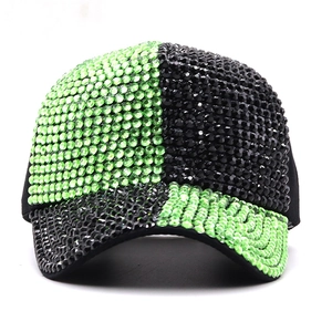 Detail of rhinestones and green-black patchwork on a glittering baseball cap