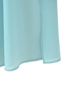 Detail of light blue chiffon fabric showing the hemline with neat rolled edge stitching