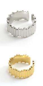 Close-up of adjustable open rings featuring vertical wave texture in gold and silver finish