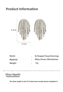 Macro shot of silver N-shaped tassel earrings with zircon details and 8.4cm dimensions