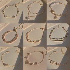 Grid view showcasing nine different vintage gold bracelets with pearls and zircons