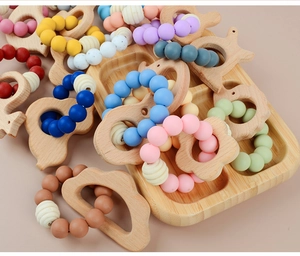 Detailed close-up of colorful food-grade silicone beads and natural beech wood teething rings