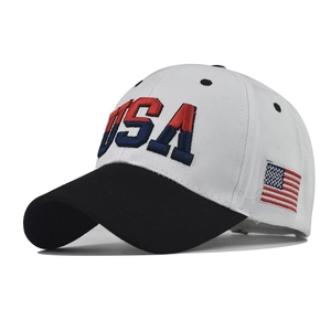 Detailed side view of USA embroidery and American flag patch on a white baseball cap