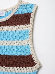 Close-up of striped knit vest showing light blue and brown texture with EUR S size label
