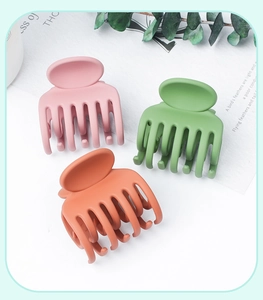 Three-piece matte hair claws set in pink, green, and coral orange resin for hairstyling