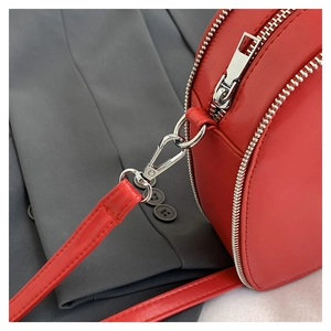 Close-up of red PU leather heart bag showing silver metal zipper and fine stitching details