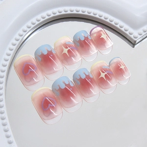 Sweet pink gradient press-on nails with blue fluid and heart patterns on a mirror