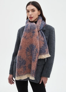 Close-up of a blue and orange floral patterned scarf with fringe details on a grey blazer