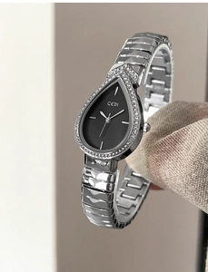 Macro view of silver water-drop case with crystal bezel and black dial on quartz watch