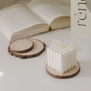 Minimalist white bubble cube scented candle on a rustic wooden base with a ribbon bow
