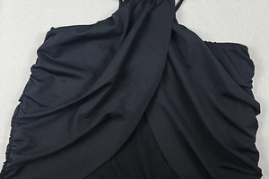Detail of cross-neck design and gathered ruched side on black backless maxi dress