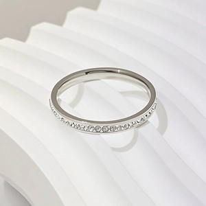 Detailed close-up of a silver-tone titanium steel ring with single-row stone inlay