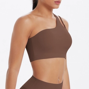 Detailed close-up of dark brown one-shoulder sports bra with seamless matte fabric texture