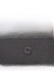 Detailed close-up of embroidered eyelets on grey baseball cap for breathability