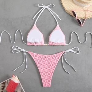 Detailed macro view of pink floral bikini fabric with textured honeycomb pattern