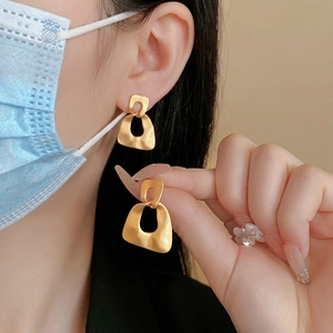 Matte gold geometric earrings with minimalist irregular hollow trapezoid drop design