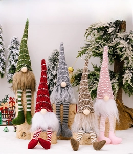 Five assorted Christmas gnomes in colorful hats sitting on tree stumps with snow background