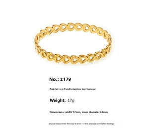 Macro detail of 18K gold-plated stainless steel hollow heart pattern bangle bracelet
