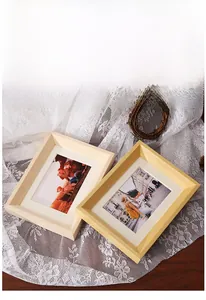 Detail view of solid wood picture frames with textured borders and lifestyle sample photos