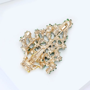 Detailed back view of a golden Christmas tree brooch with secure safety pin clasp