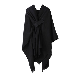 Solid black knitted shawl poncho with front tie knot and fringe hem detail