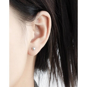 Minimalist S925 sterling silver heart stud earring shown worn on female ear lobe