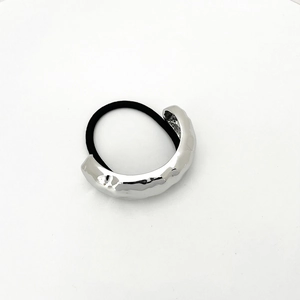Detailed close-up of high-elasticity hair tie with silver hammered metal U-shape buckle