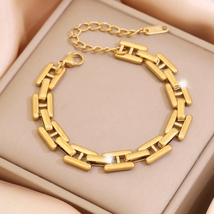 Elegant gold pig nose chain bracelet on beige jewelry box with silk fabric backdrop