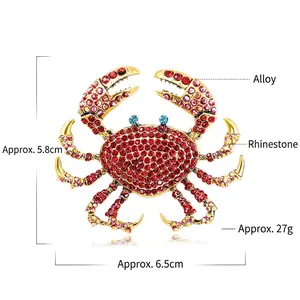 Exaggerated rhinestone crab brooch in gold alloy with red crystals and dimension markings