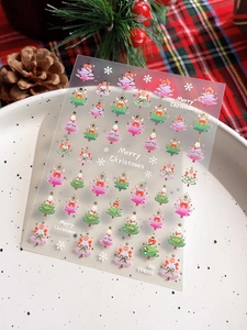 Detail of Christmas nail art stickers with gold foil tree patterns and festive decorations
