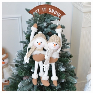 Christmas snowman plush hanger with Let It Snow banner on a frosted tree