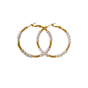 French vintage hoop earrings with white pearls and textured gold segments on white background
