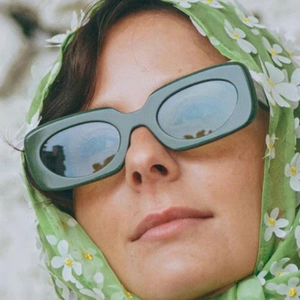2025 trendy square sunglasses in dark green finish, worn with a vintage floral headscarf