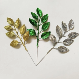 Detailed view of artificial glitter leaves in gold, green and silver for Christmas DIY