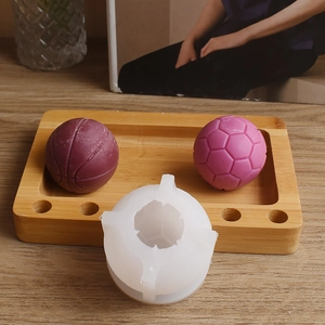 Macro detail of silicone ball mold with textured basketball and soccer candle samples