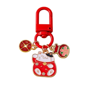 Chinese lucky cat keychain with red fortune bag and golden copper coin charms