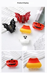 Detail showing a variety of colorful Halloween hair clips with pumpkin and bat designs