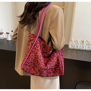 Detailed macro shot of pink leopard print fabric texture on a stylish tote bag