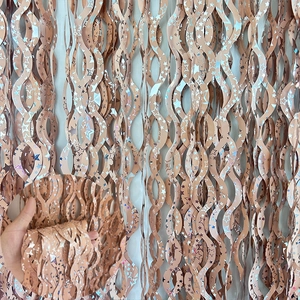 Detail of light brown tinsel curtain with holographic star patterns for party decor