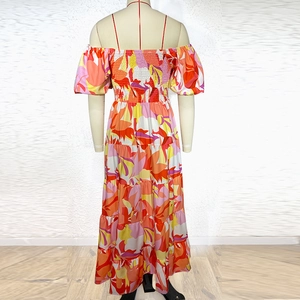 Detailed back view of a high-waisted floral maxi dress with elastic smocking and puff sleeves