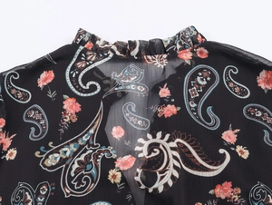 Detail of ruffle collar on chiffon paisley blouse with pink floral pattern