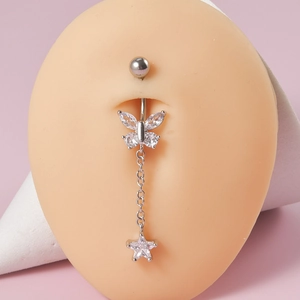 Detail of silver butterfly belly ring with sparkling zircon star pendant on a silicone model