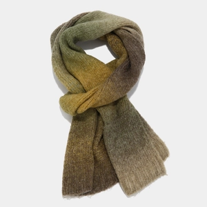 Detailed view of tie-dye knitted scarf with gradient olive and ginger wool yarn texture